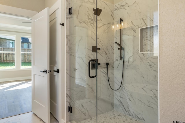 bathroom featuring a shower with door