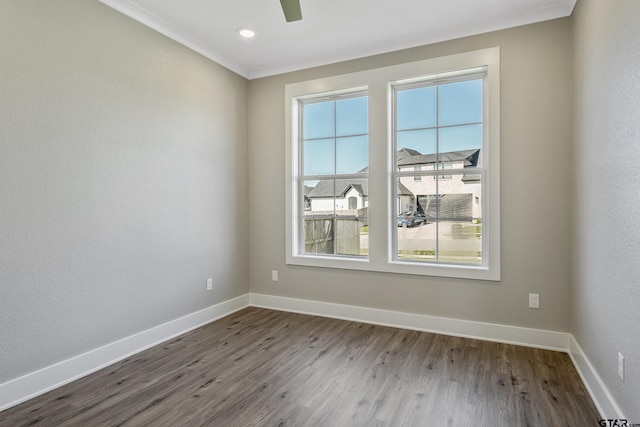 empty room featuring hardwood / wood-style floors, ceiling fan, and ornamental molding