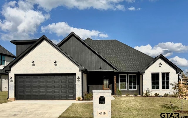 view of front facade featuring a garage and a front lawn