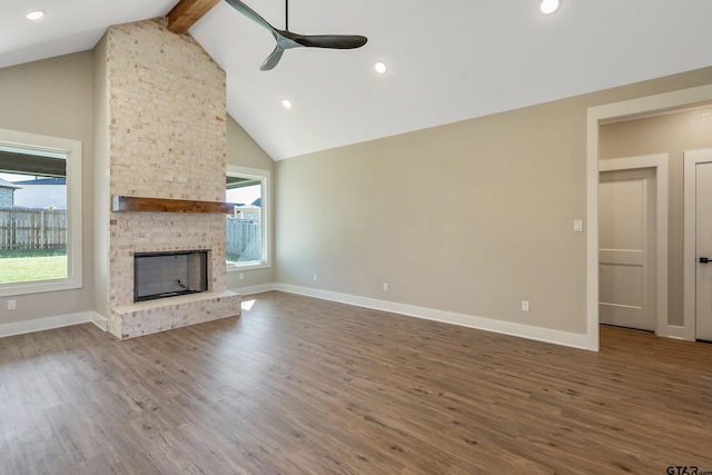 unfurnished living room with wood-type flooring, ceiling fan, and beam ceiling