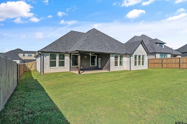 rear view of property featuring a patio and a yard