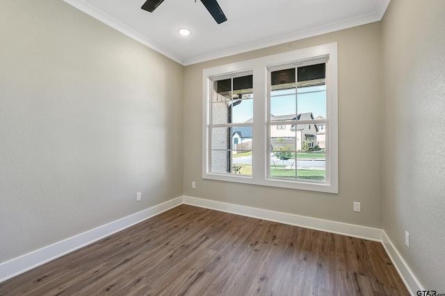 empty room featuring ceiling fan, wood-type flooring, and ornamental molding