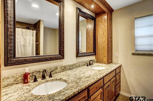 bathroom with tile patterned flooring and vanity