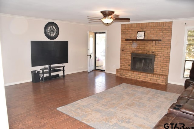 living room with a healthy amount of sunlight, dark hardwood / wood-style flooring, and crown molding