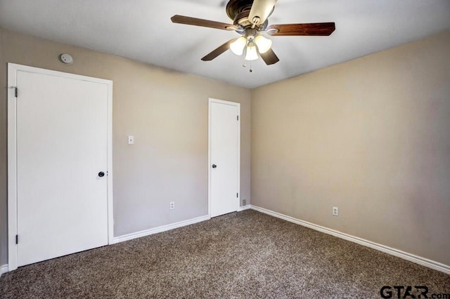 spare room with carpet flooring and ceiling fan