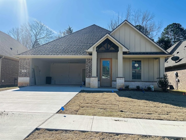 view of front of property with a garage, a shingled roof, concrete driveway, board and batten siding, and brick siding