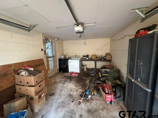 garage with washer and clothes dryer and a garage door opener