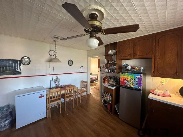 kitchen with ceiling fan, dark wood-type flooring, stainless steel refrigerator, and fridge