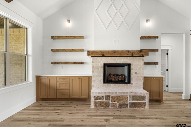 11905 Tara Ln, Lindale, TX 75771 - living room with light wood-style floors, high vaulted ceiling, a fireplace, and baseboards