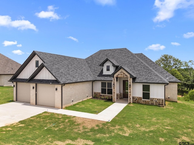 11905 Tara Ln, Lindale, TX 75771 - view of front of home featuring board and batten siding, a front yard, a shingled roof, and driveway