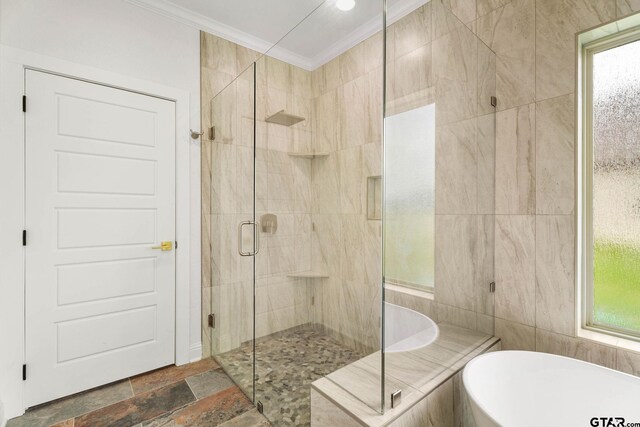 11905 Tara Ln, Lindale, TX 75771 - bathroom featuring a shower stall, a soaking tub, ornamental molding, and tile walls