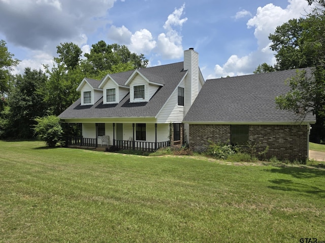 115 Pearson Ln, Longview, TX 75604 - cape cod home with a porch, a chimney, a front lawn, a shingled roof, and brick siding