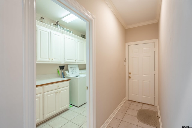 laundry area featuring cabinets, light tile patterned floors, ornamental molding, and washing machine and dryer