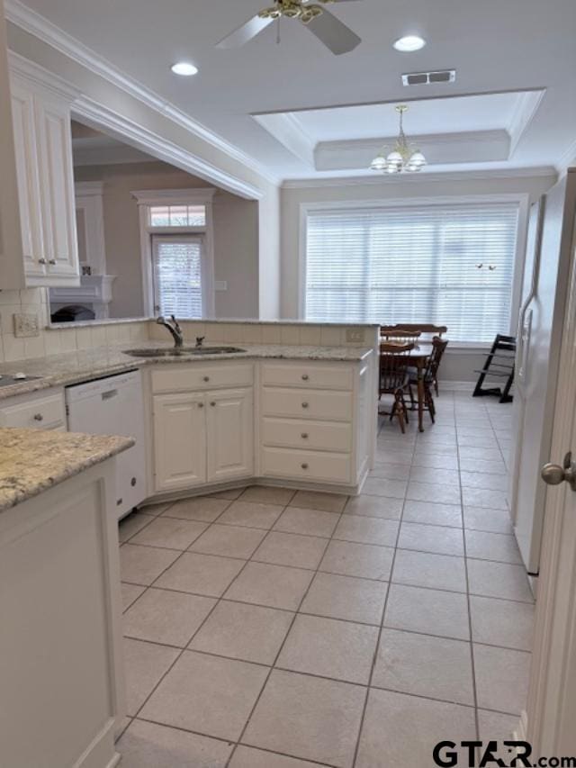 kitchen featuring white cabinets, white appliances, sink, and a tray ceiling