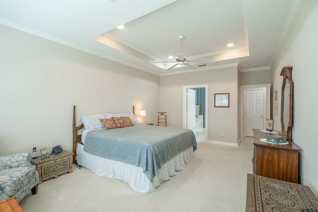 bedroom with ensuite bath, ceiling fan, a raised ceiling, crown molding, and light carpet