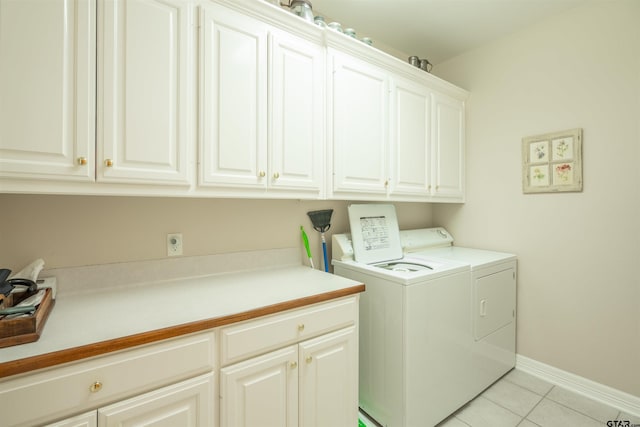 clothes washing area with cabinets, light tile patterned floors, and separate washer and dryer