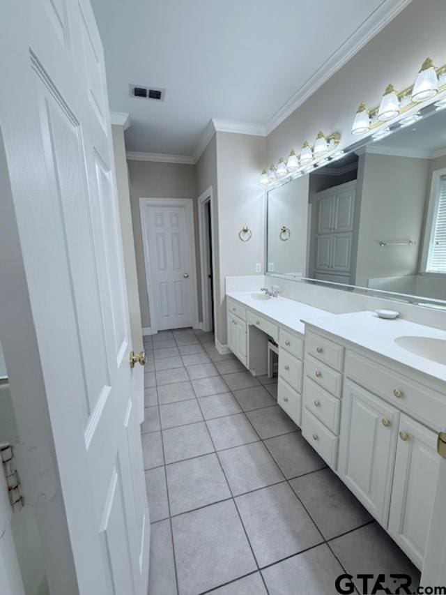 bathroom featuring tile patterned flooring, vanity, and crown molding