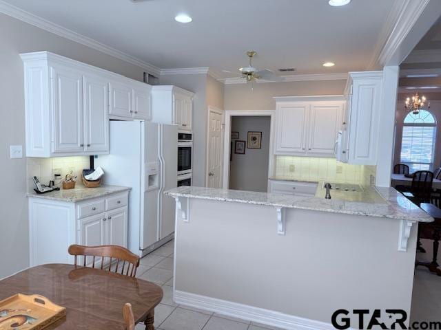 kitchen featuring kitchen peninsula, white cabinetry, and light tile patterned flooring