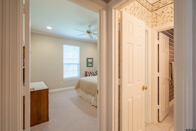 bedroom with ceiling fan, light colored carpet, and crown molding