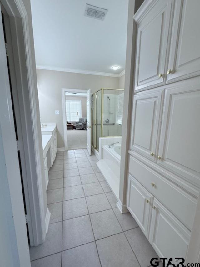 bathroom featuring tile patterned flooring, shower with separate bathtub, vanity, and crown molding