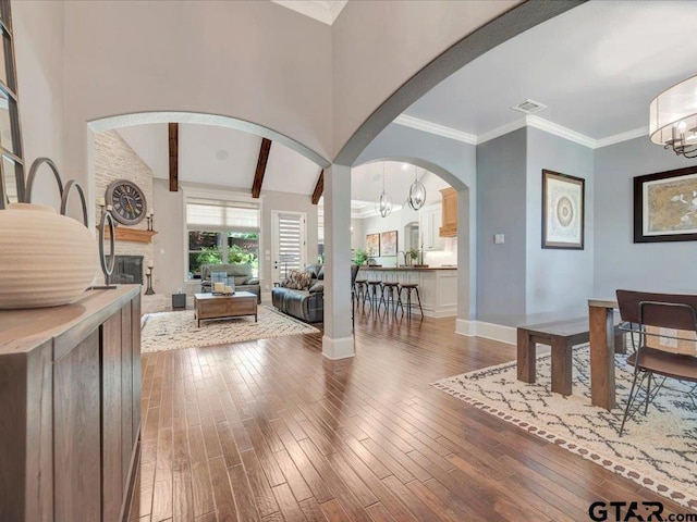 foyer featuring visible vents, arched walkways, and hardwood / wood-style floors