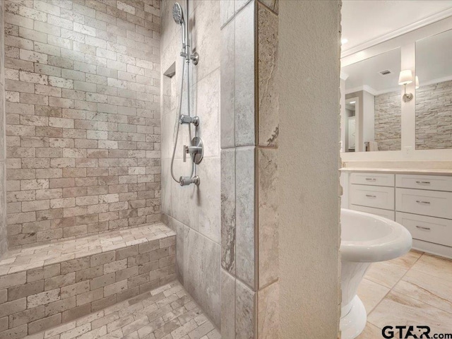 bathroom featuring crown molding and tiled shower