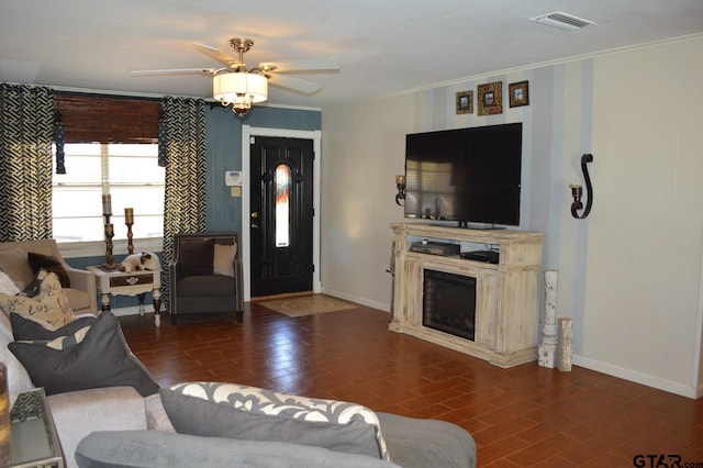 living room featuring ornamental molding and ceiling fan