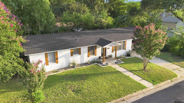 ranch-style house with a front lawn