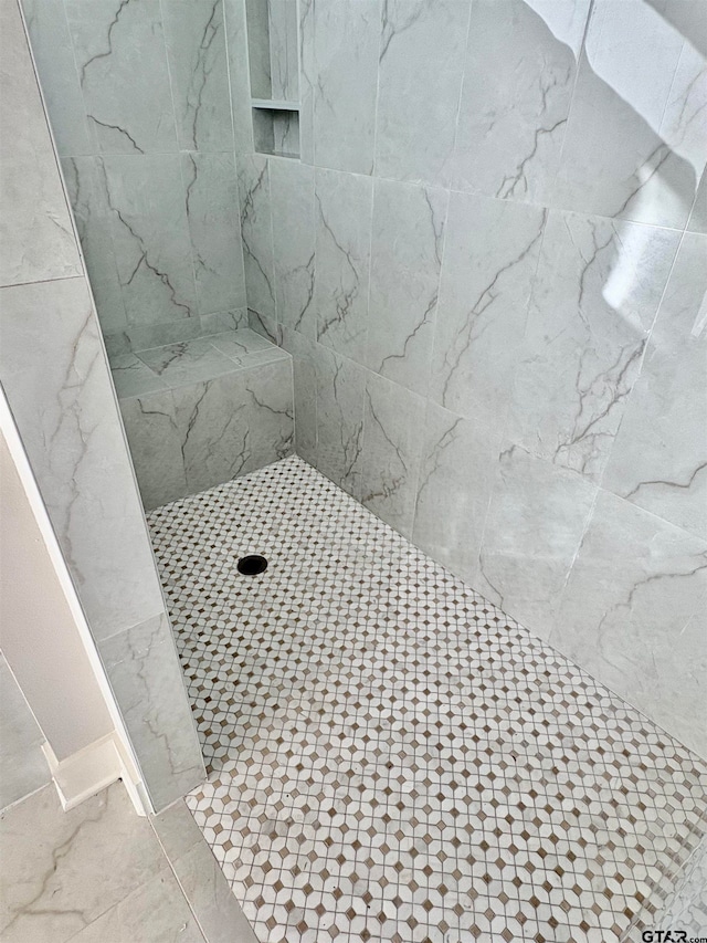 bathroom with tiled shower