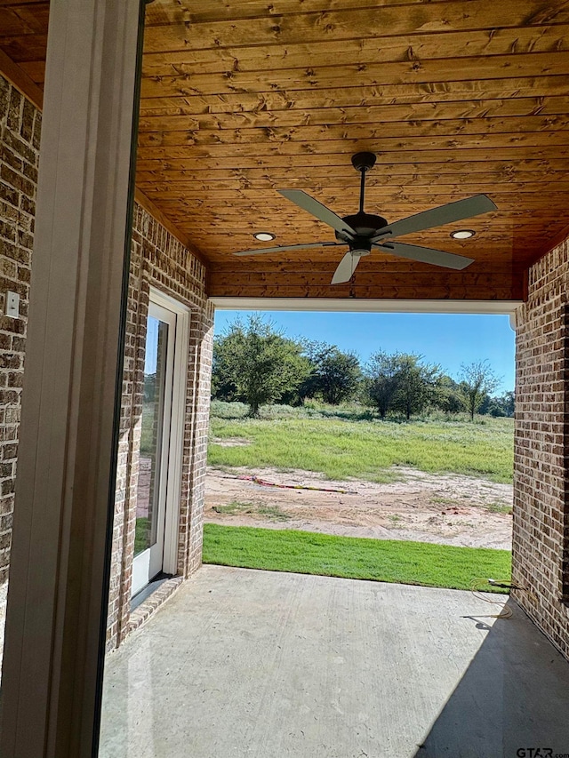 view of patio with ceiling fan and a rural view