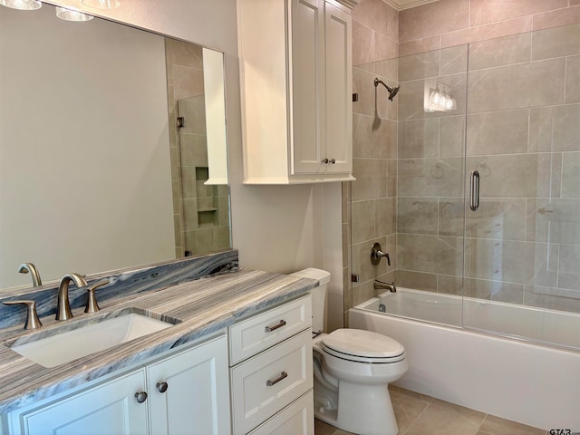 full bathroom with toilet, vanity, tile patterned floors, and enclosed tub / shower combo