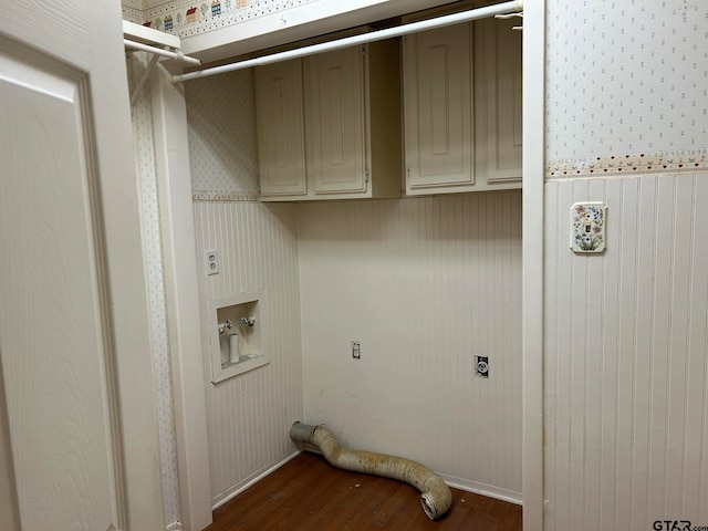 laundry room featuring washer hookup, dark hardwood / wood-style flooring, cabinets, wooden walls, and electric dryer hookup