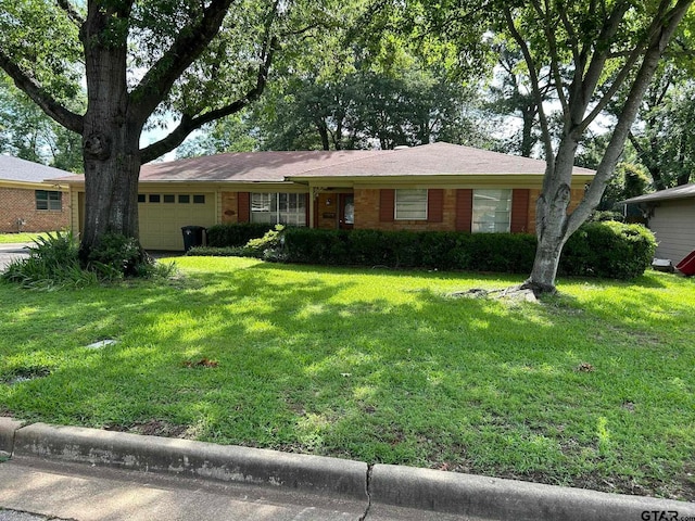 ranch-style home featuring a front lawn and a garage