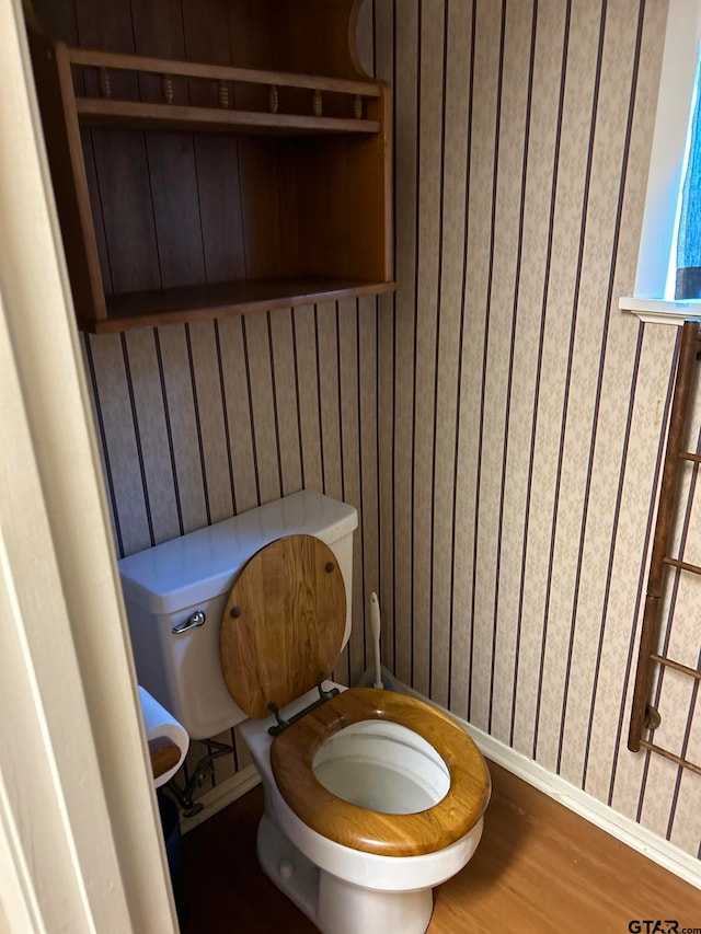 bathroom featuring hardwood / wood-style flooring and toilet