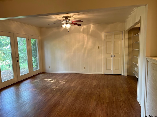 empty room with ceiling fan, dark hardwood / wood-style floors, plenty of natural light, and french doors