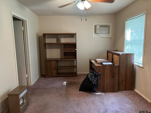 unfurnished office with a wall mounted air conditioner, ceiling fan, and dark carpet