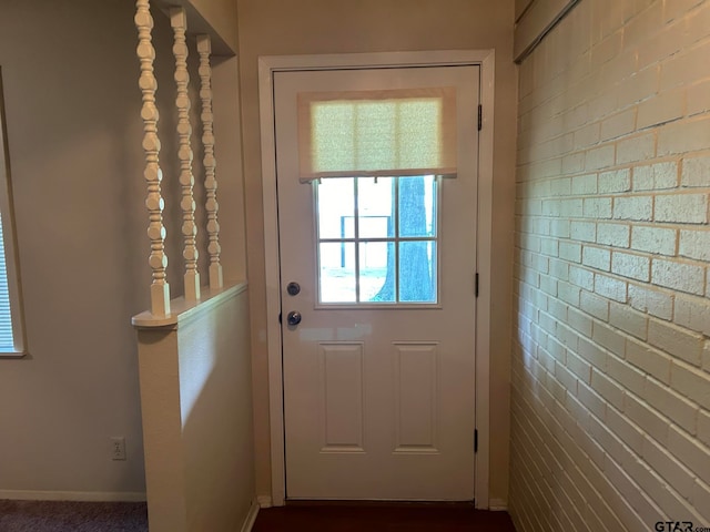 entryway with brick wall