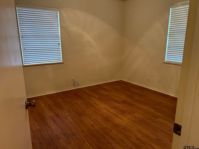 empty room with dark wood-type flooring