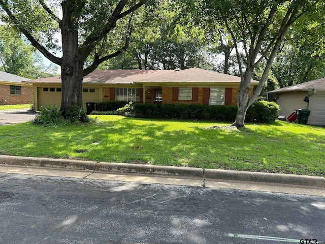 ranch-style house with a garage and a front yard