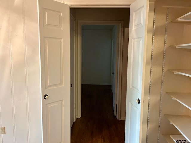 corridor featuring dark hardwood / wood-style floors