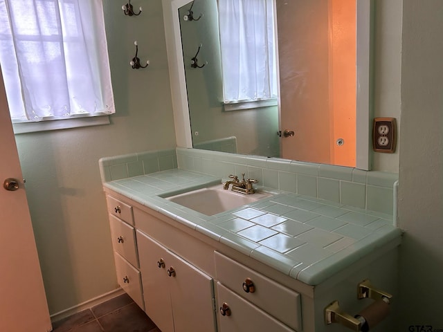 bathroom with tile patterned flooring, decorative backsplash, and vanity