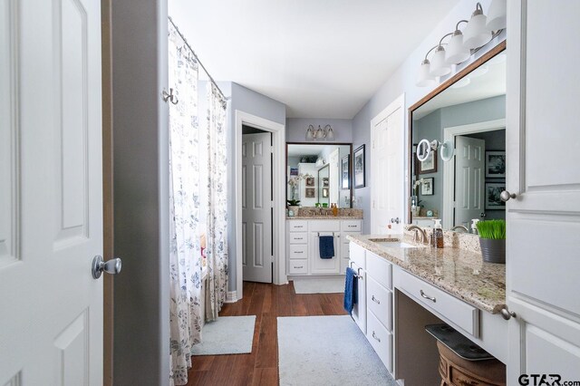 laundry area with dark hardwood / wood-style flooring, cabinets, and separate washer and dryer