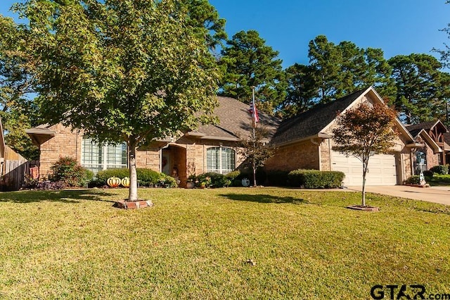 ranch-style home with driveway, an attached garage, a front lawn, and brick siding