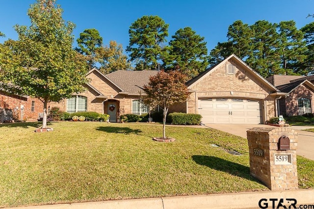 view of front of property with a front lawn and a garage