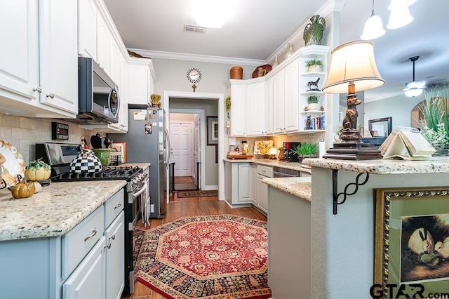 kitchen with ornamental molding, white cabinetry, appliances with stainless steel finishes, decorative light fixtures, and dark hardwood / wood-style flooring