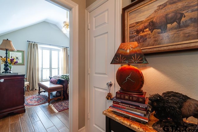 interior space featuring hardwood / wood-style floors and vaulted ceiling