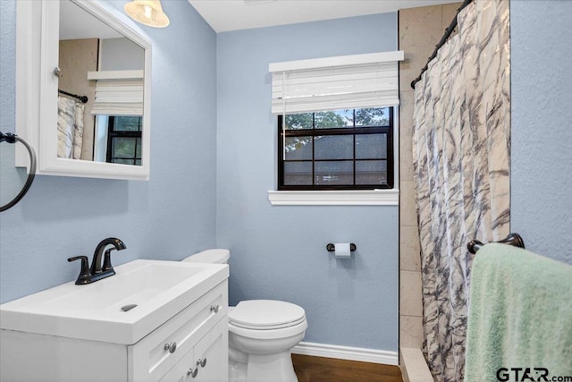 107 W Nutbush, Tyler, TX 75702 - full bath with vanity, a shower with shower curtain, wood finished floors, and a textured wall