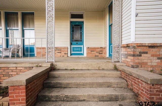 view of exterior entry with covered porch