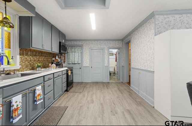 kitchen with electric range, light hardwood / wood-style flooring, gray cabinetry, and sink