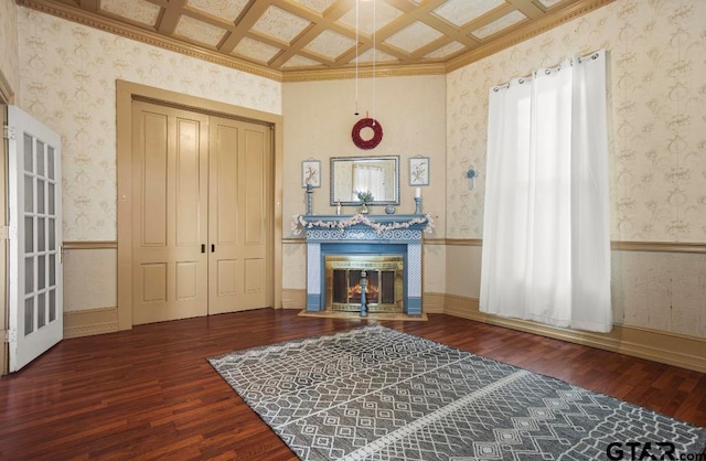 interior space with beam ceiling, dark wood-type flooring, crown molding, and coffered ceiling